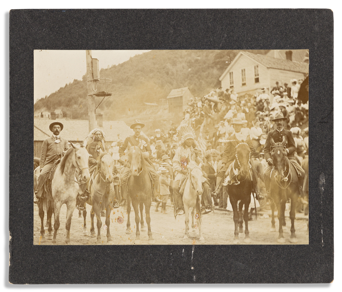 (WEST--SOUTH DAKOTA.) Photograph of famed Deadwood lawman Seth Bullock on parade, flanked by American Indians.